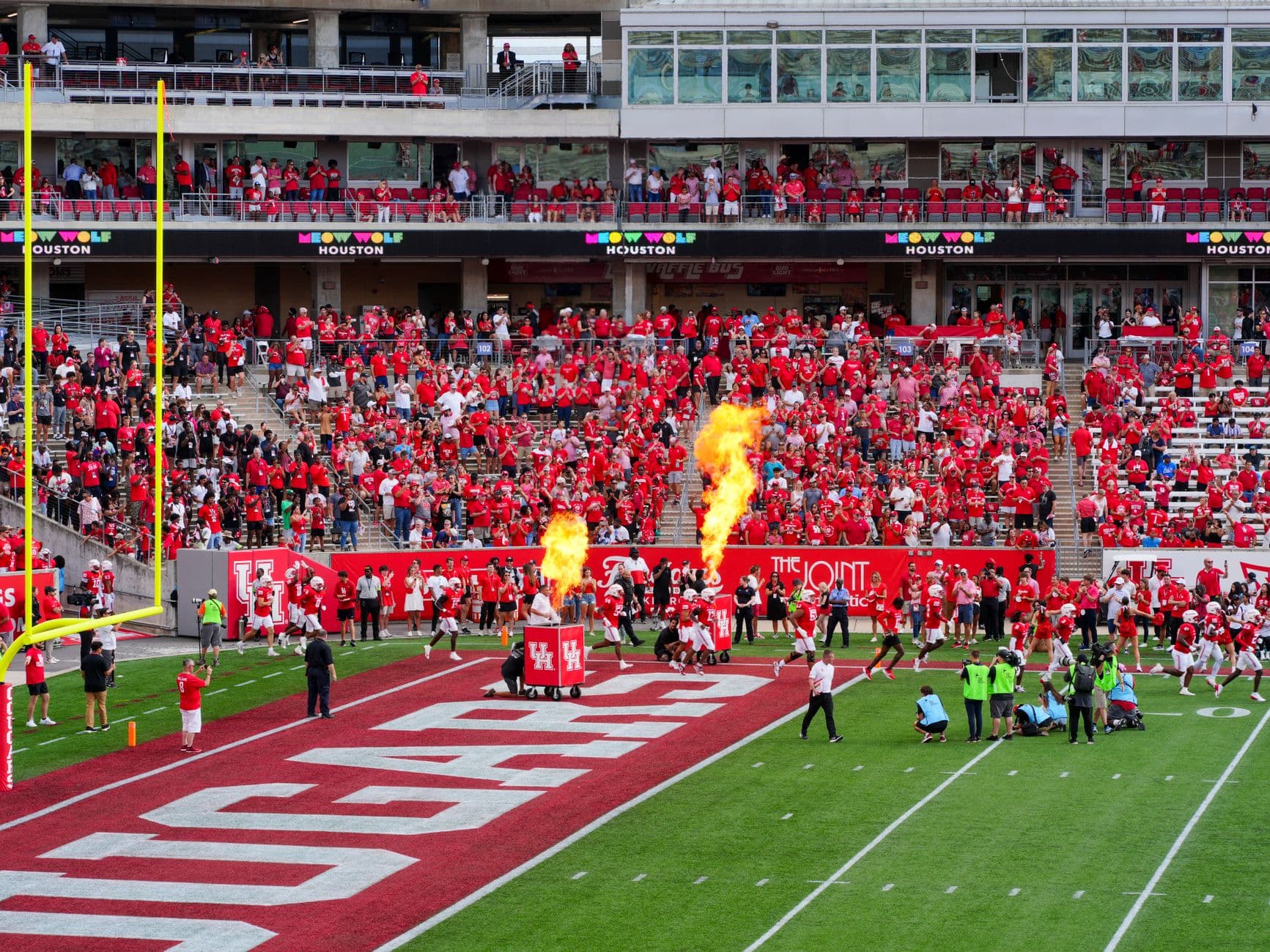 Houston college football match with vibrant crowd and fire effects. Captures the sports spirit.